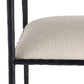 Close-up of a chair with a textured beige cushion and black metal frame on a white background