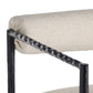 Close-up of a chair with a textured beige cushion and black metal frame on a white background