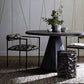 Dining room with a dark wooden table, chairs, and a woven pendant light.