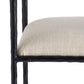 Close-up of a chair with a textured beige seat and black metal frame on a white background