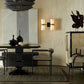 Dining room with a chandelier, wall sconces, and decorative items.