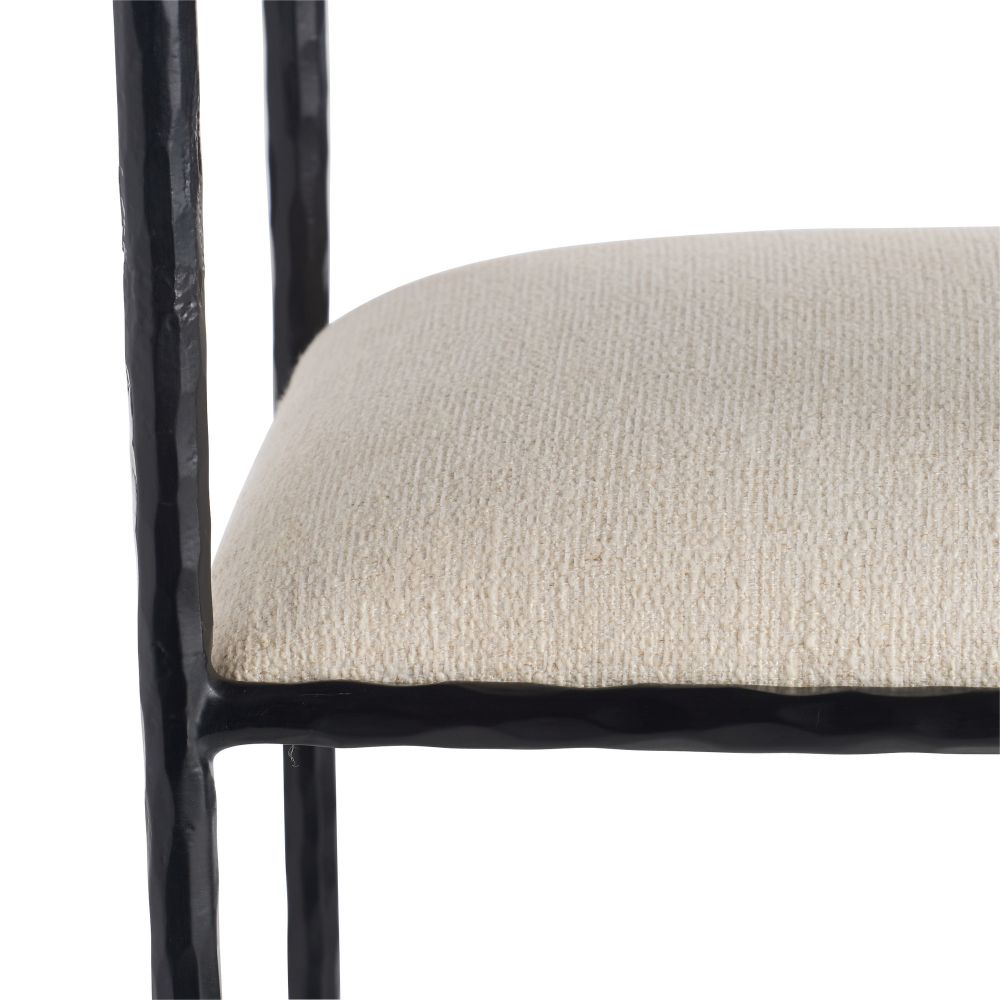 Close-up of a chair with a black frame and beige cushion on a white background