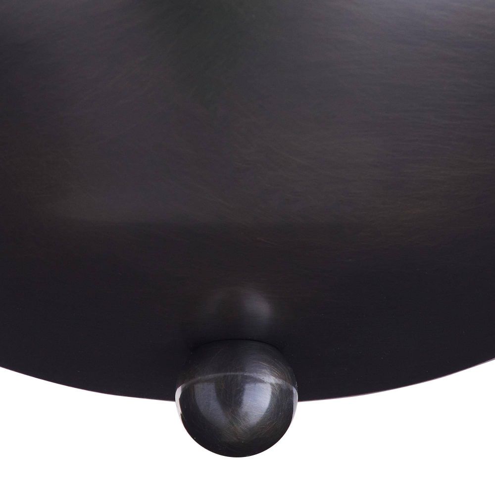 Close-up of a black leather armchair with a spherical metal knob on a white background
