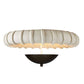 Decorative wall light fixture with a textured white shade on a white background