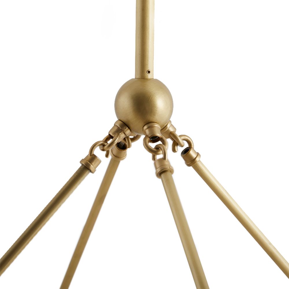 Close-up of a gold decorative object with a spherical top and four arm-like extensions on a white background.