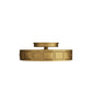 Gold circular decorative object with geometric patterns on a white background
