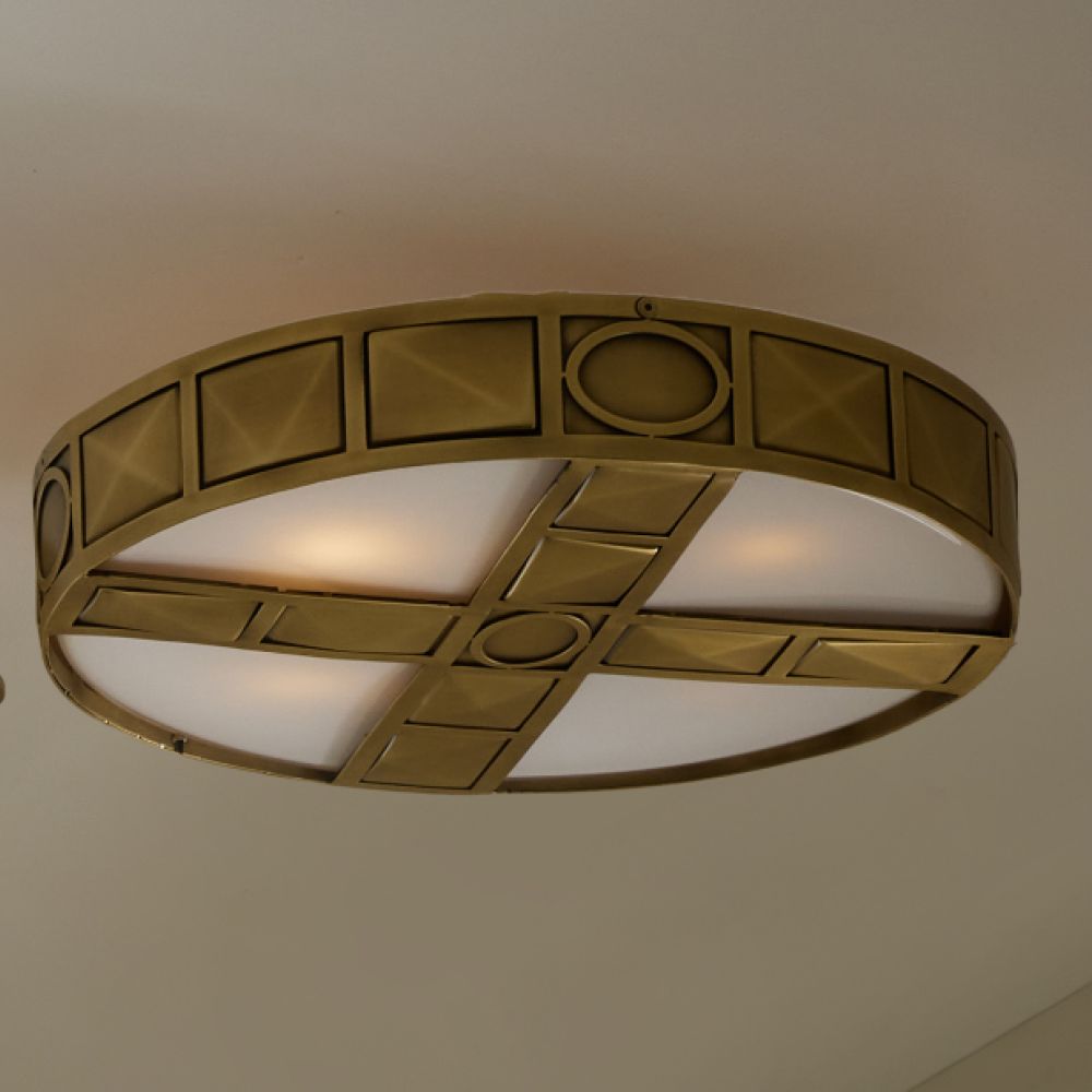 Decorative ceiling light fixture with geometric design on a plain background