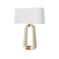 Table lamp with a white shade and gold accents on a white background