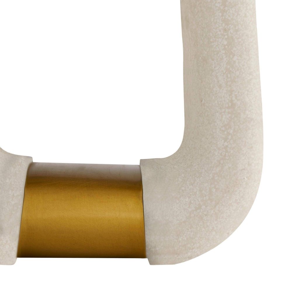Close-up of a chair arm with beige fabric and gold metal accent on a white background