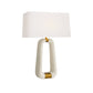 Table lamp with a white shade and gold accents on a white background