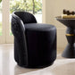 Black swivel chair in a room with a window and side table.