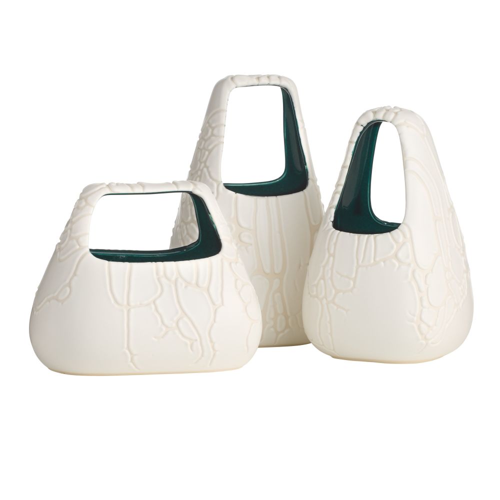Set of three white ceramic vases with green accents on a white background