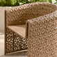 Woven outdoor chair with intricate pattern on a blurred natural background