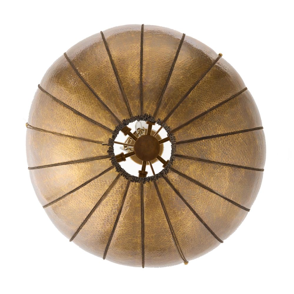 Round gold lampshade with ribbed texture on a white background