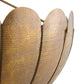 Close-up of a textured gold lampshade with a white background