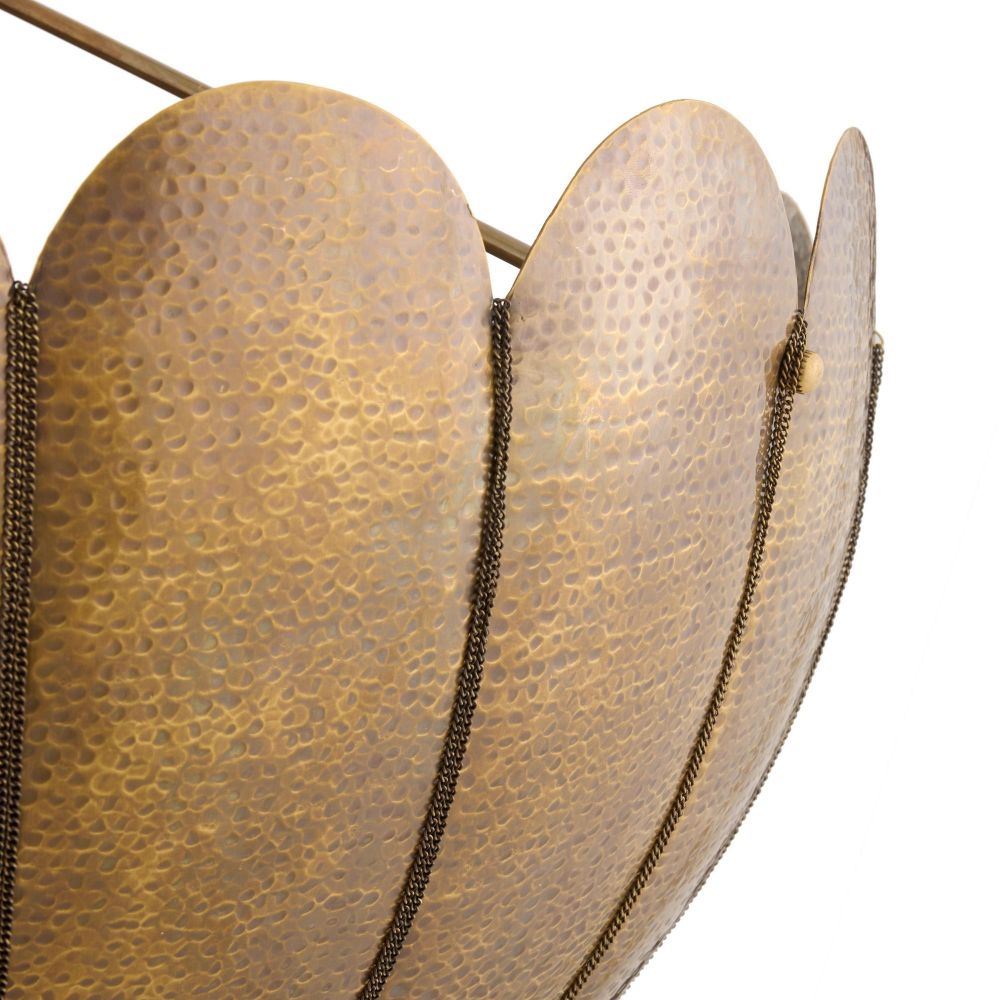 Close-up of a textured gold lampshade with a white background