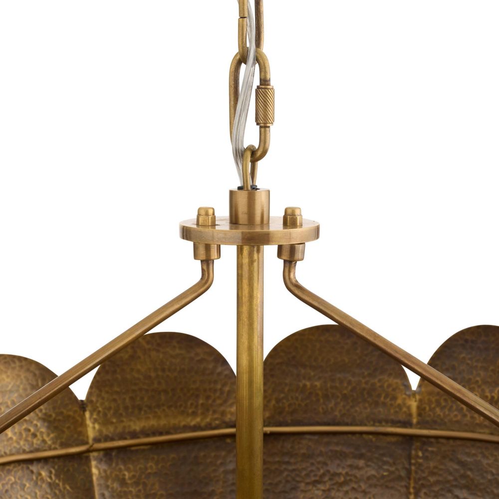 Close-up of a brass pendant light fixture with a white background