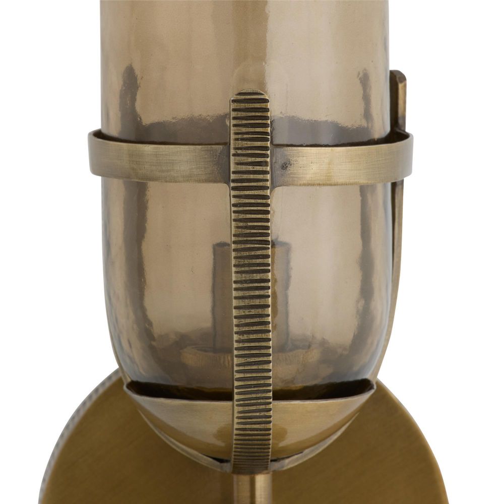 Close-up of a metallic object with a gear-like design on a white background