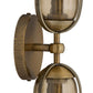 Close-up of a brass wall sconce with glass shades on a white background