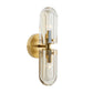 Gold wall sconce with clear glass on a white background