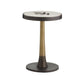 Small round table with a bronze base and white top on a white background