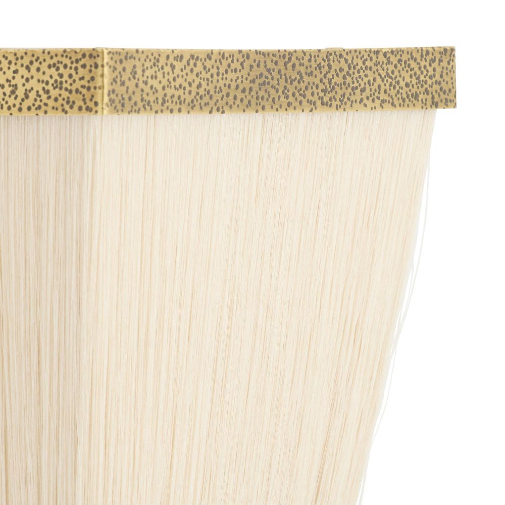 close up detail of a Beige sconce with gold trim on a white background