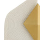 Close-up of a textured beige surface with a gold geometric shape.