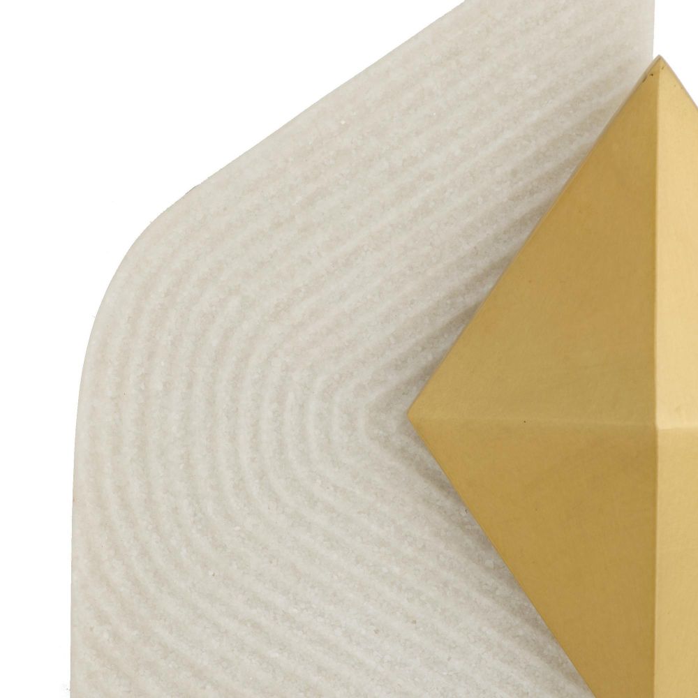 Close-up of a textured beige surface with a gold geometric shape.