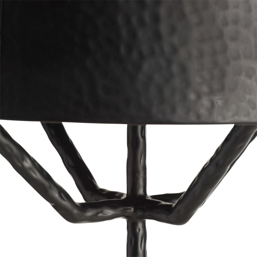 Close-up of a black metal chair with a textured backrest on a white background