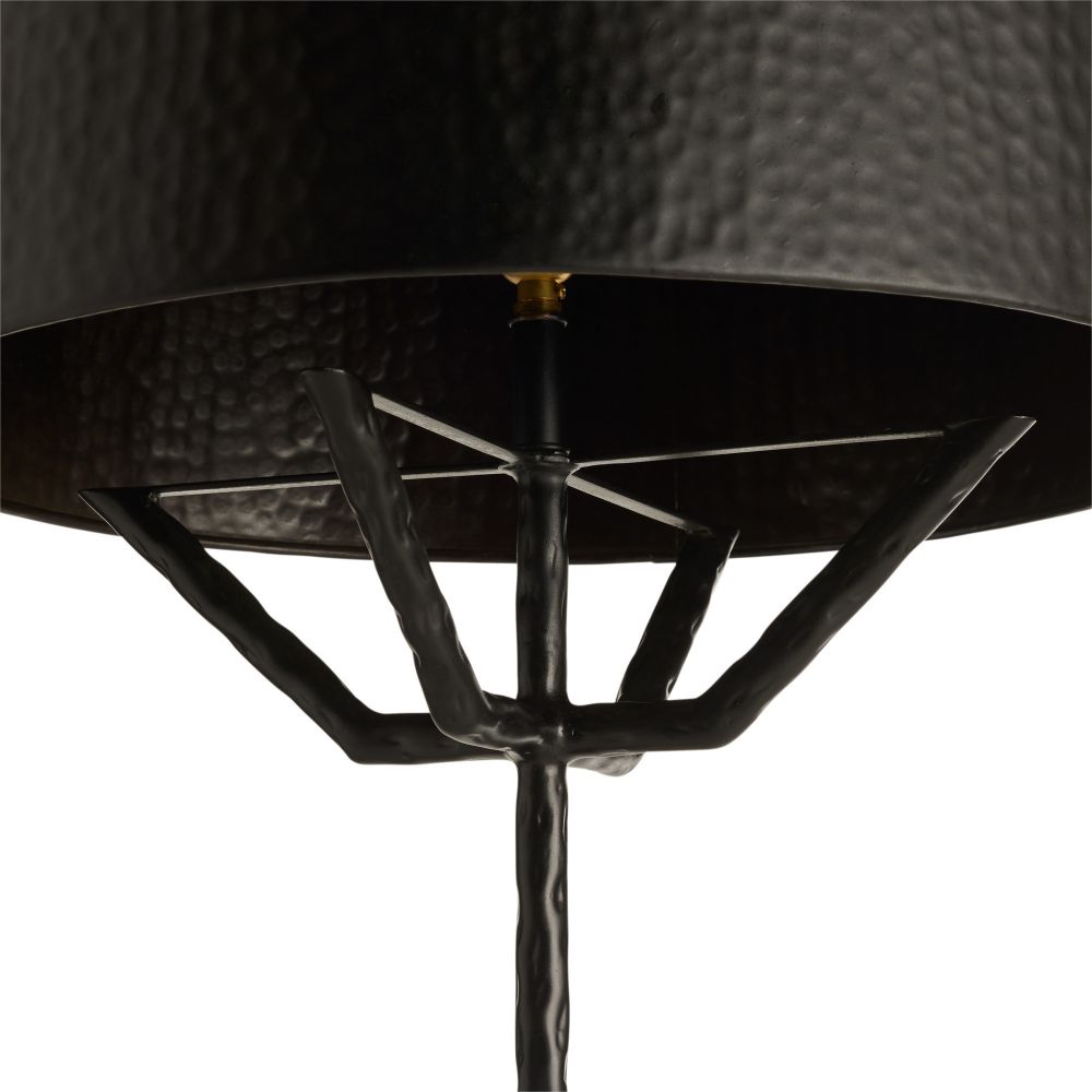 Close-up of a black metal lamp with a textured shade on a white background