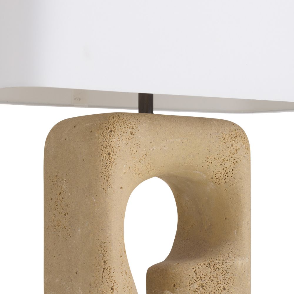 Beige stone table lamp with a white shade on a light gray background