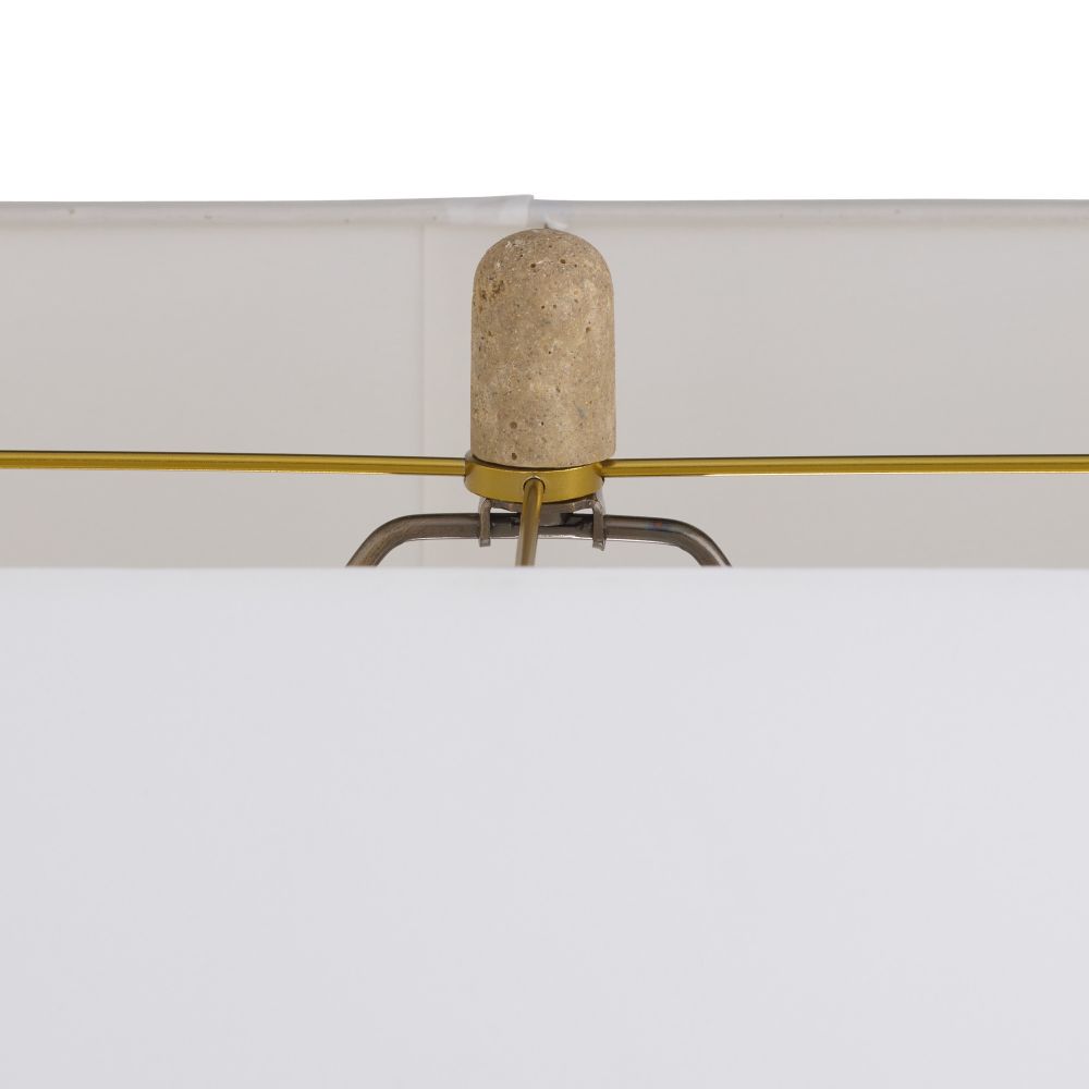 Decorative lamp with a cylindrical beige shade and gold arm on a white background