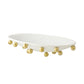 White oval tray with gold spherical accents on a white background