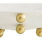 Close-up of a white surface with gold spherical embellishments