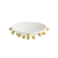 White plate with gold beads on a white background