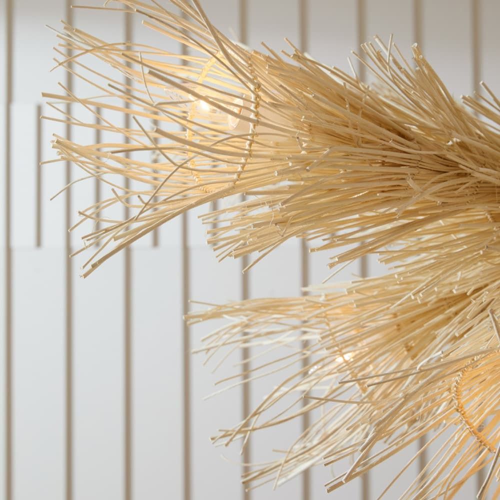 Close-up of a decorative gold plant against a white paneled wall
