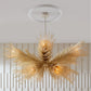 Modern chandelier with gold leaf design on a neutral background