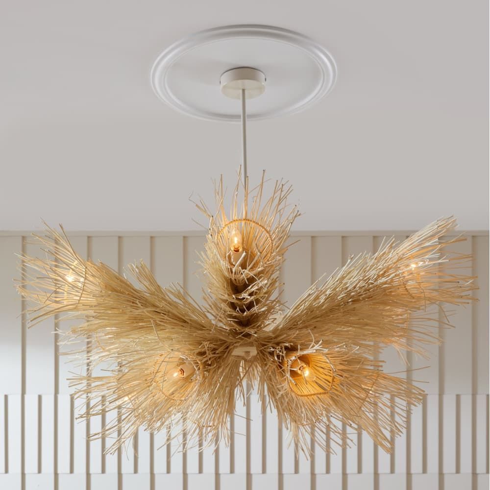 Modern chandelier with gold leaf design on a neutral background
