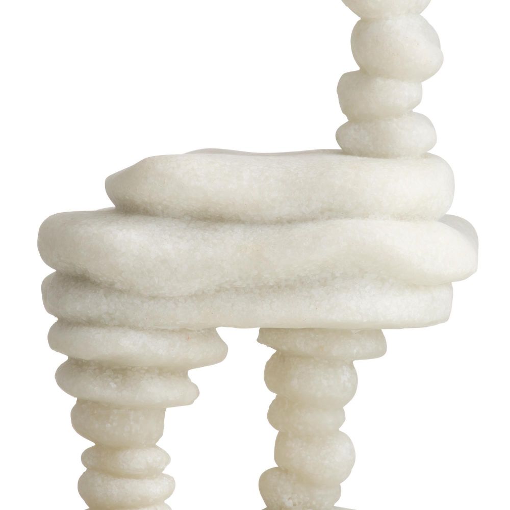 White marble sculpture with spiral design on a white background