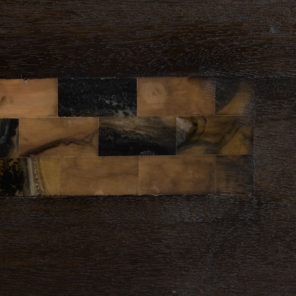 Close-up of a dark brown leather texture with a patterned border