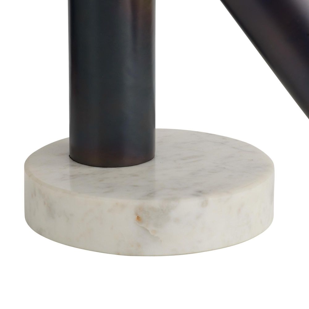 Close-up of a black cylindrical object on a white marble base