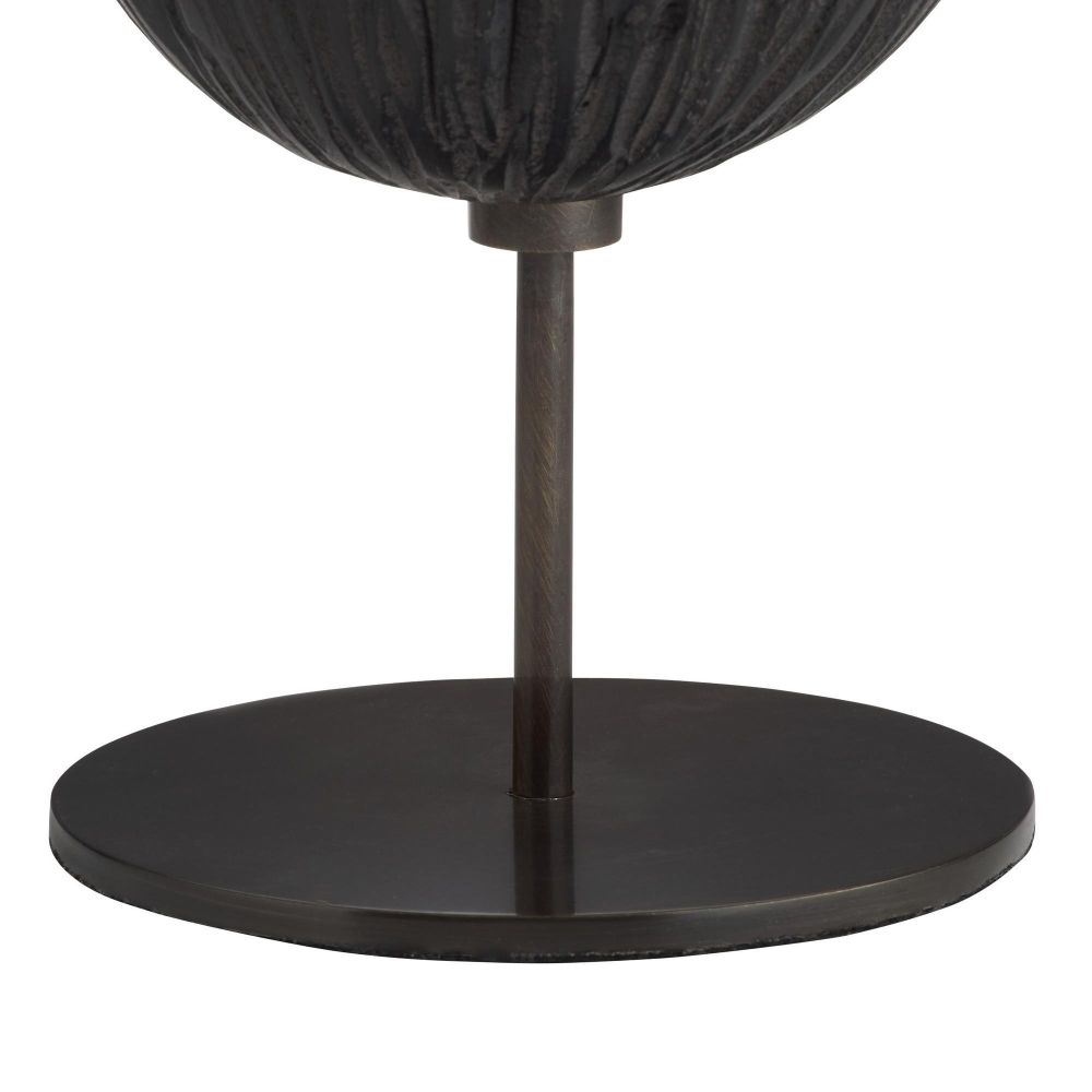 Black decorative object with a spherical top and cylindrical base on a white background
