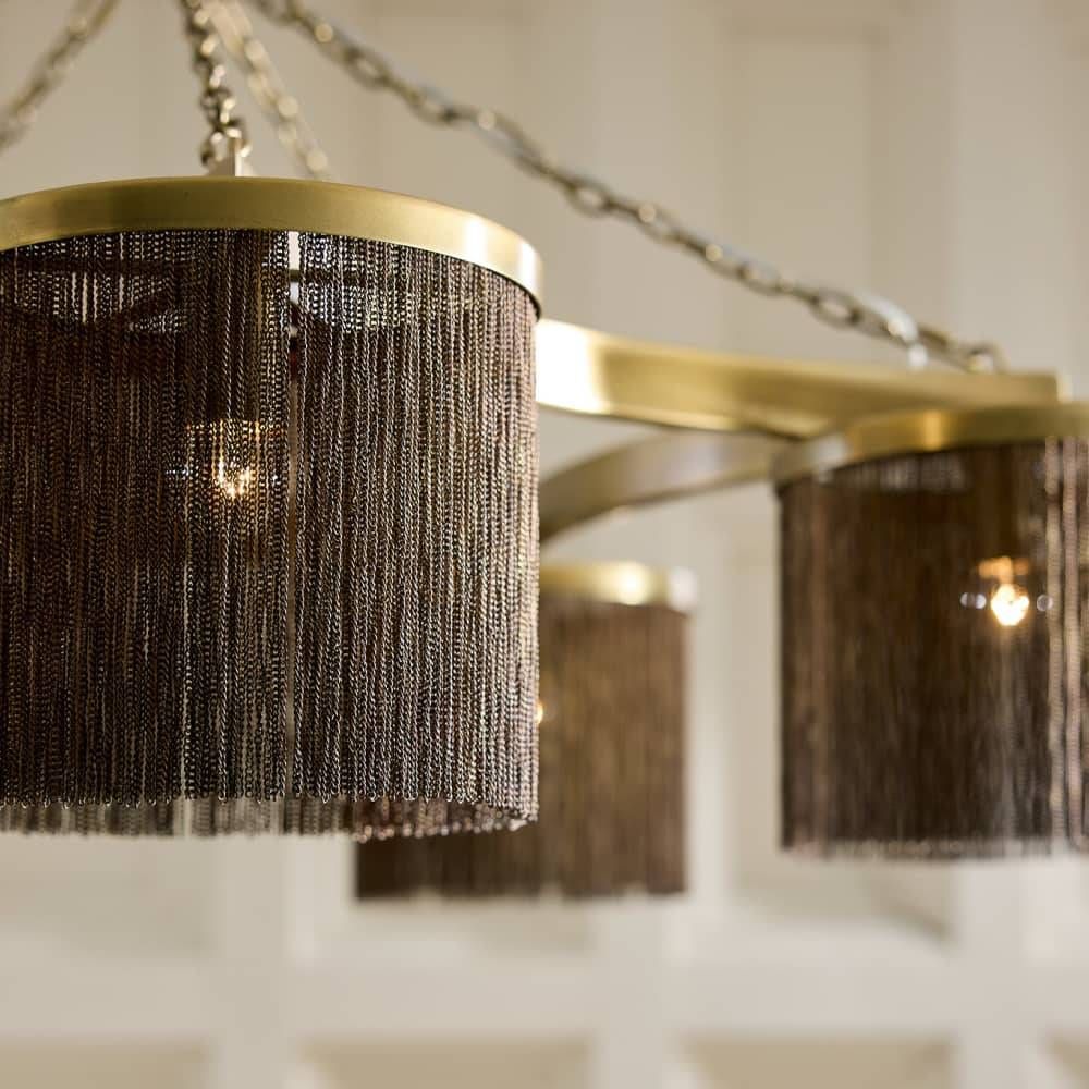 Chandelier with gold frame and black fringe design on a blurred background