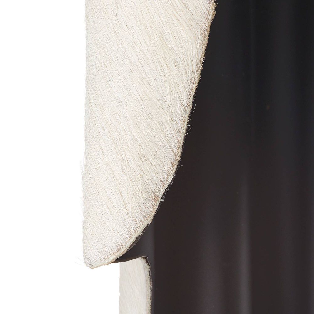 Close-up of a textured white and black sconce