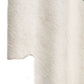 Close-up of a textured white sconce with a subtle pattern