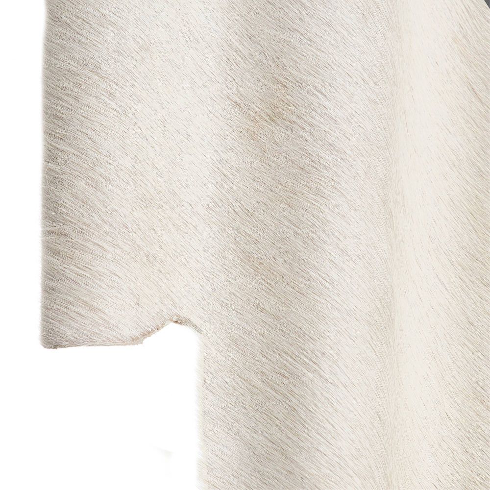 Close-up of a textured white sconce with a subtle pattern