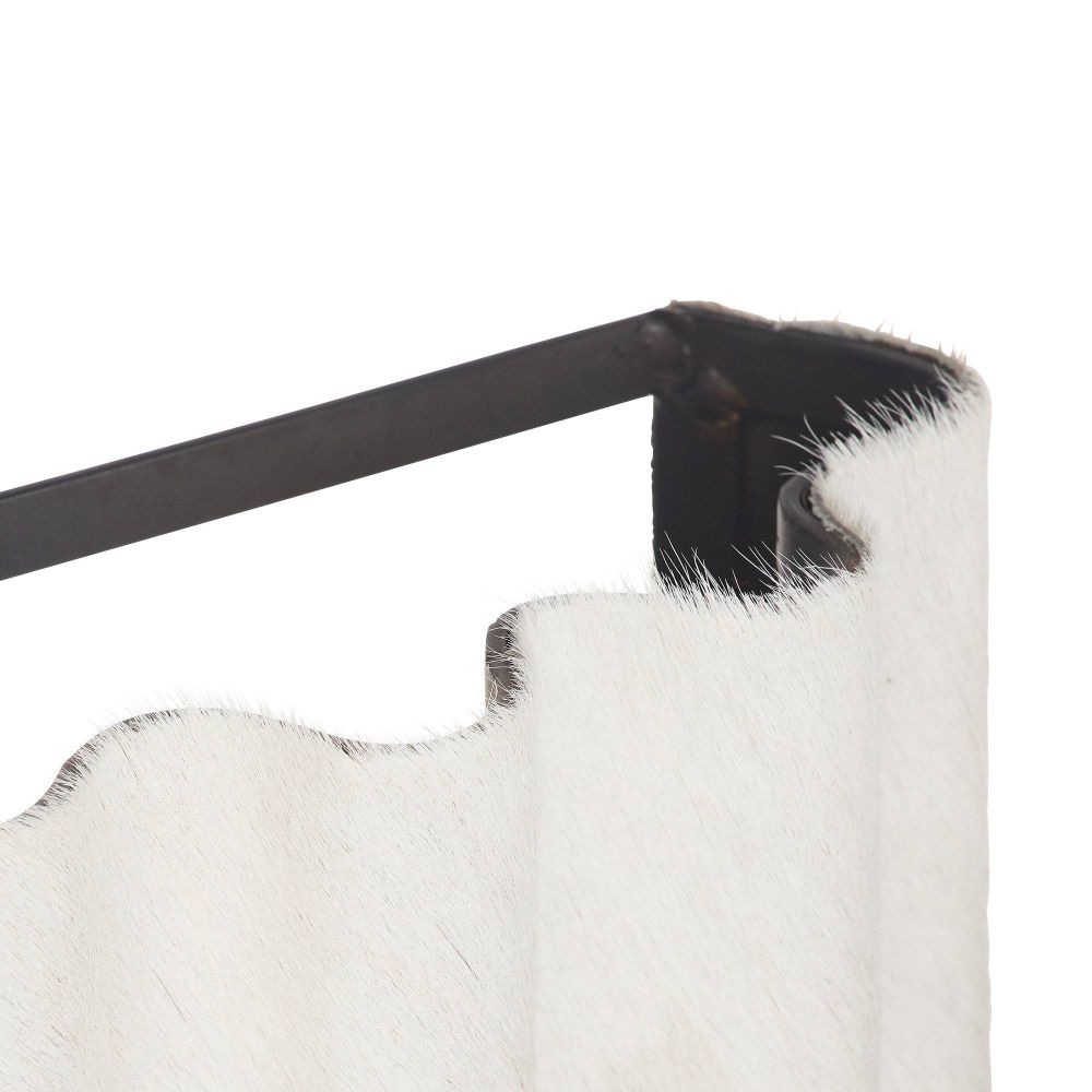 Close-up of a black and white hide sconce with a metal frame.