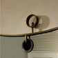 Decorative wall-mounted shelf with circular design on a neutral background