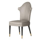 Beige chair with black legs and gold tips on a white background