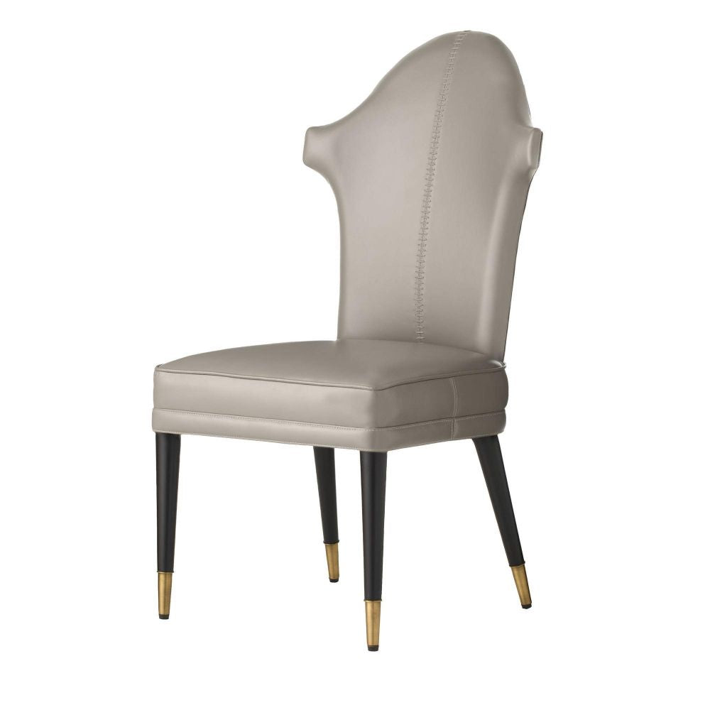 Beige chair with black legs and gold tips on a white background
